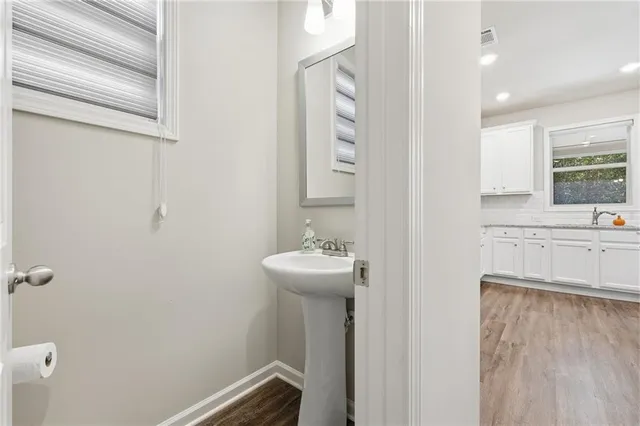 a bathroom with a sink a toilet and mirror
