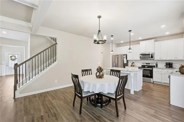 a view of a dining room kitchen with furniture and wooden floor