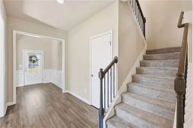 a view of an entryway with wooden floor and door