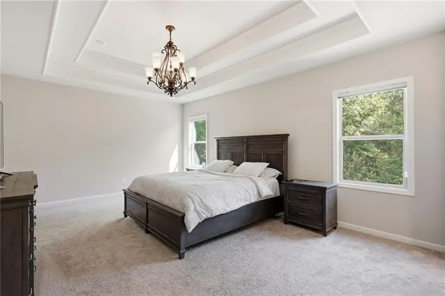 a spacious bedroom with a bed and a window