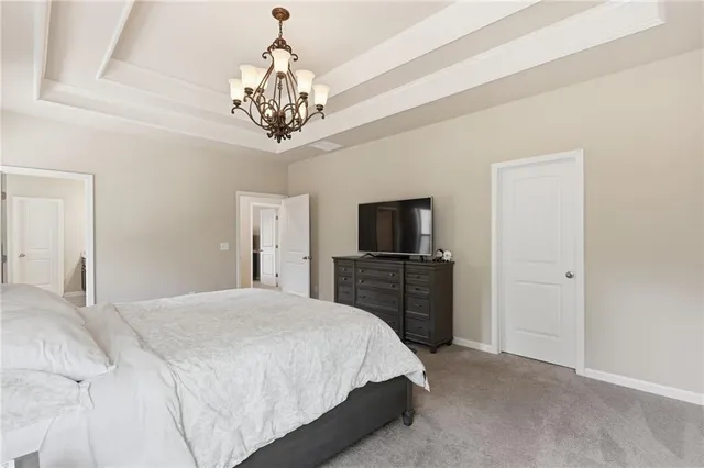 a bedroom with a chandelier and a bed