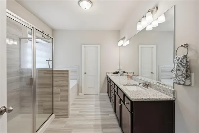 a bathroom with a sink vanity granite and a mirror