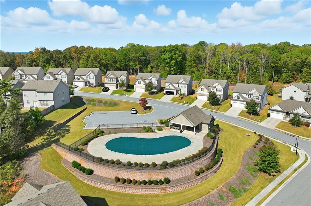 3247 Hawthorne Path Braselton, GA 30517 - Photo 3 of 44 a view of a swimming pool with a lounge chair