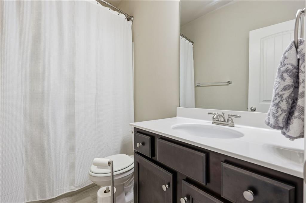 3247 Hawthorne Path Braselton, GA 30517 - Photo 33 of 44 a bathroom with a sink a toilet and a mirror