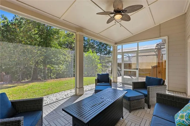 a living room with pool table chairs and a table
