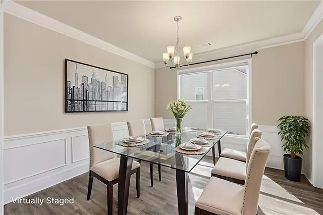 a view of a dining room with furniture and chandelier