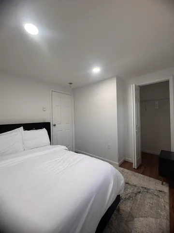 a bedroom with a bed and a closet