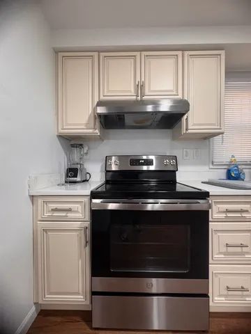 a stove top oven sitting inside of a kitchen