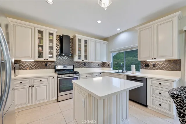 a large kitchen with a table and chairs