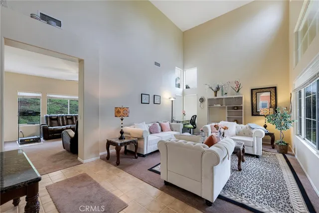 a living room with furniture large window and a table