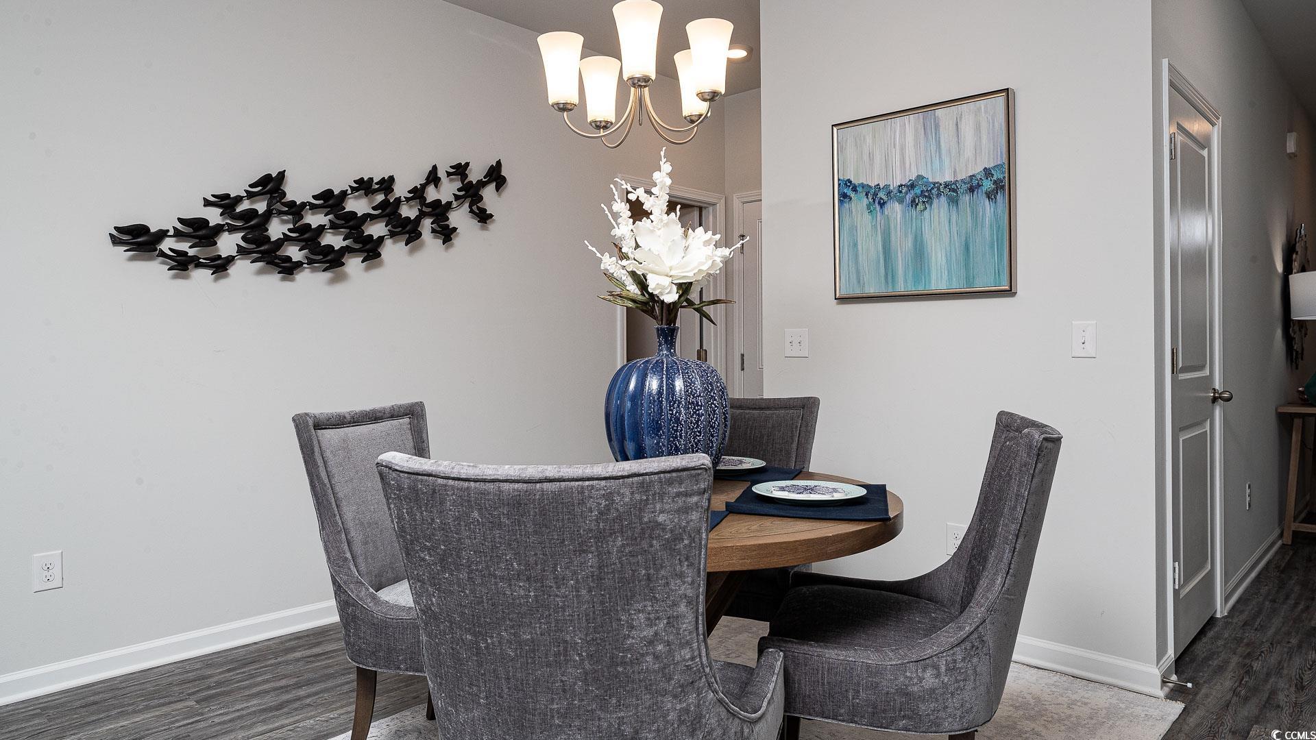1029 St Martin Street Georgetown, SC 29440 - Photo 6 of 23 Dining space featuring a chandelier and dark wood finished floors