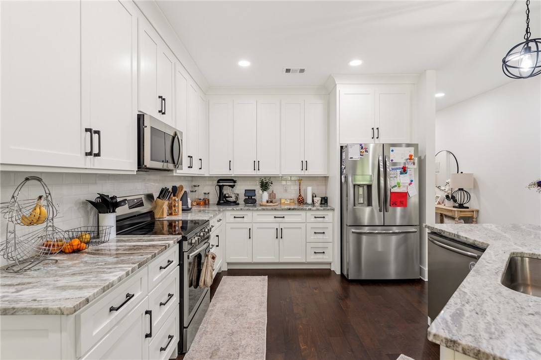 502 Canebrake Drive Anderson, SC 29621 - Photo 13 of 39 This spacious kitchen offers ample cabinet storage and stainless steel appliances, creating a bright and functional culinary space.