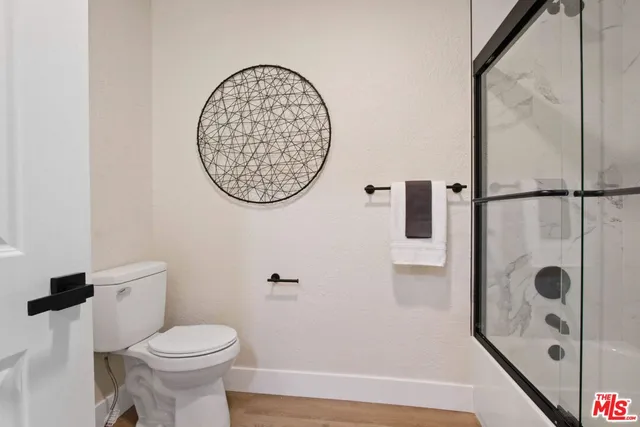 a bedroom with bed and a potted plant