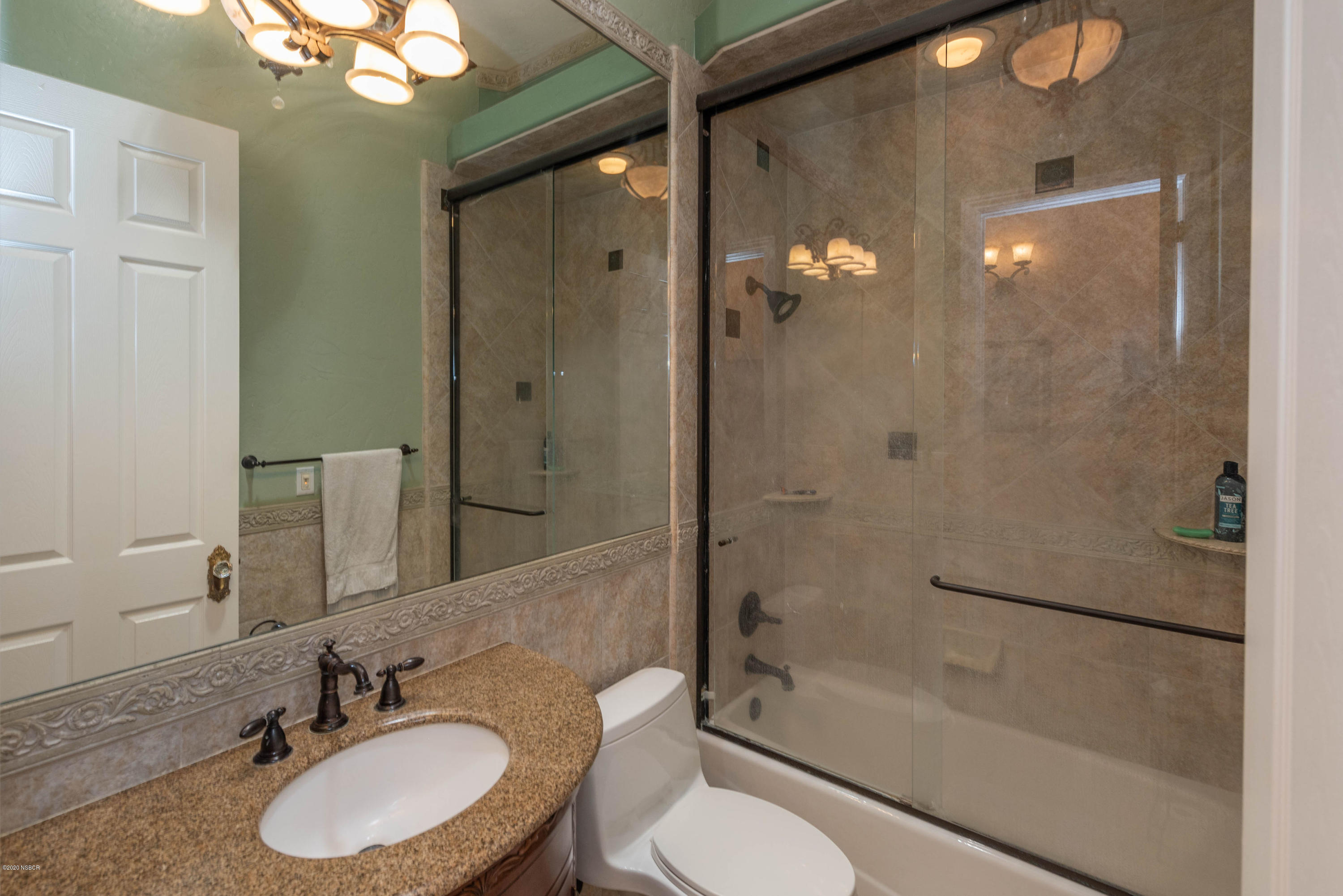 2610 Le Valley Road Lompoc, CA 93436 - Photo 13 of 36 a bathroom with a granite countertop sink toilet mirror and shower