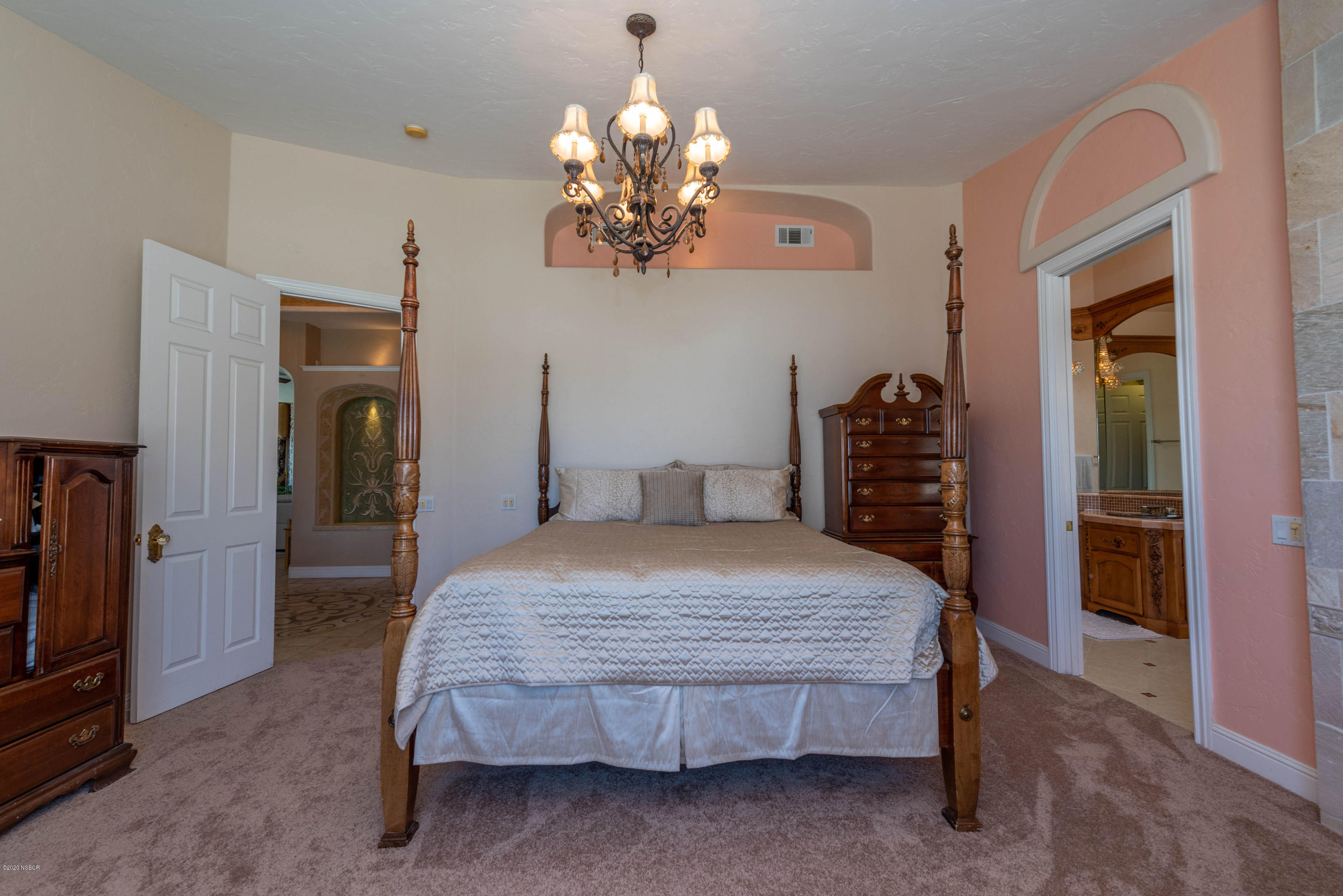 2610 Le Valley Road Lompoc, CA 93436 - Photo 14 of 36 a bedroom with a bed and a chandelier