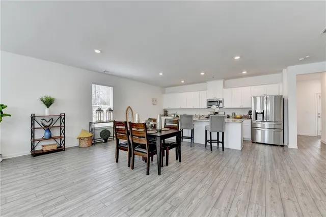 a view of a dining room with furniture and wooden floor