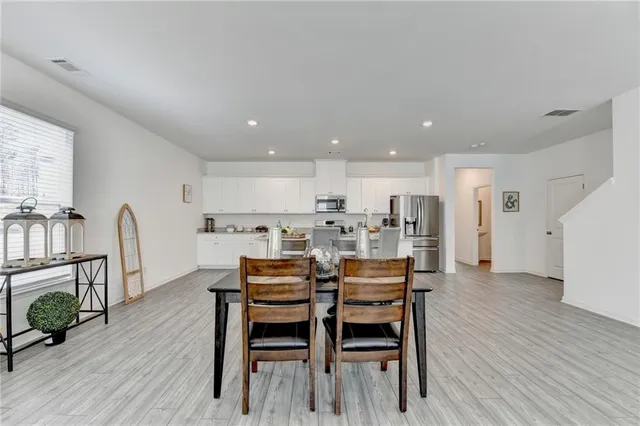a dining room with furniture and wooden floor