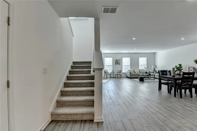 a view of entryway and dining room and wooden floor