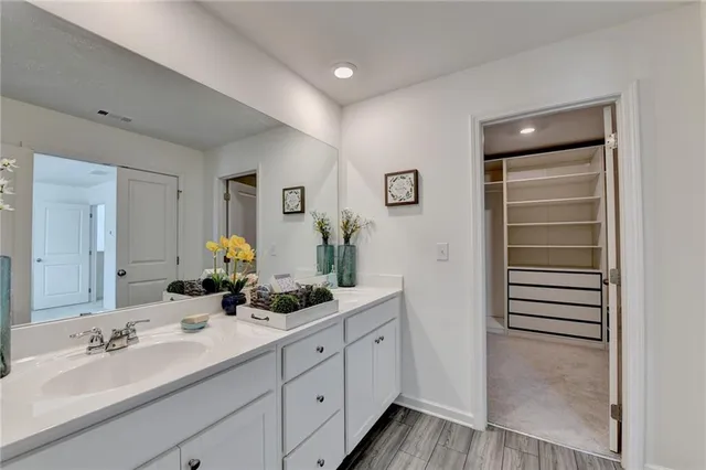 a bathroom with a double vanity sink and mirror