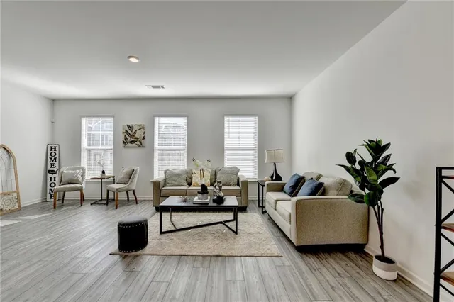 a living room with furniture and wooden floor