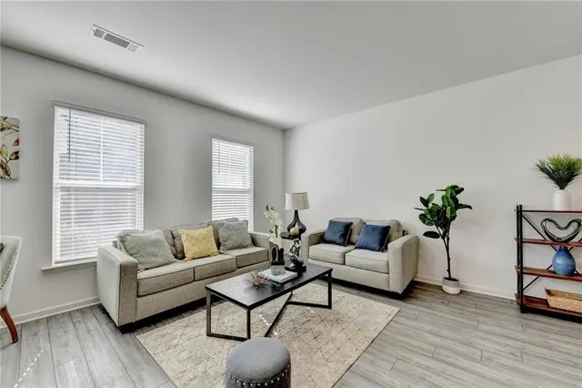 a living room with furniture and a potted plant