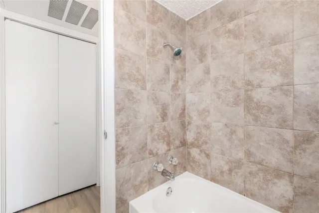 a bathroom with a shower and a toilet
