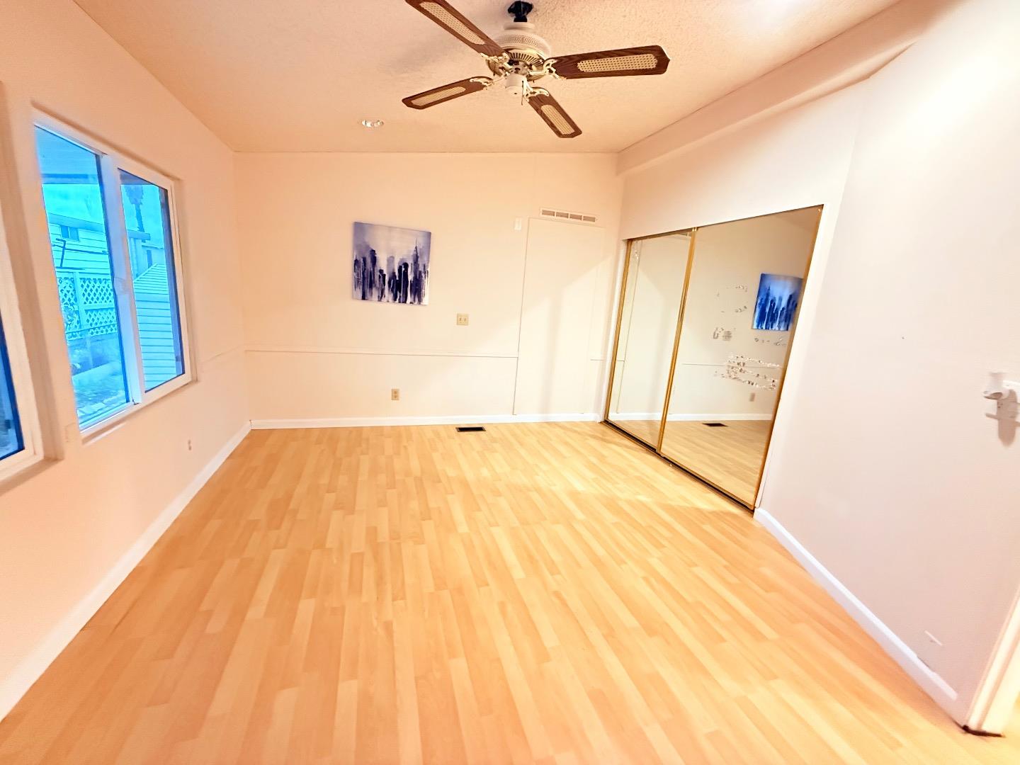 411 Lewis Road, Unit 335 San Jose, CA 95111 - Photo 18 of 27 a view of a room with wooden floor and white walls