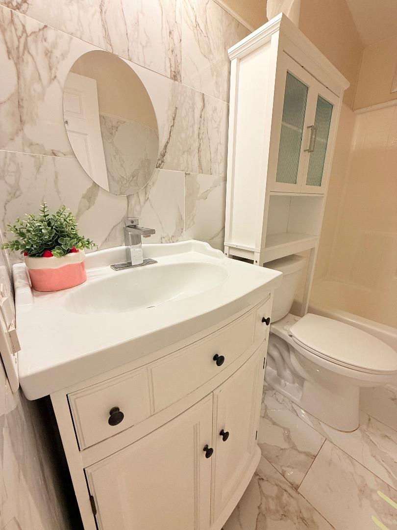411 Lewis Road, Unit 335 San Jose, CA 95111 - Photo 22 of 27 a bathroom with a sink a toilet and mirror