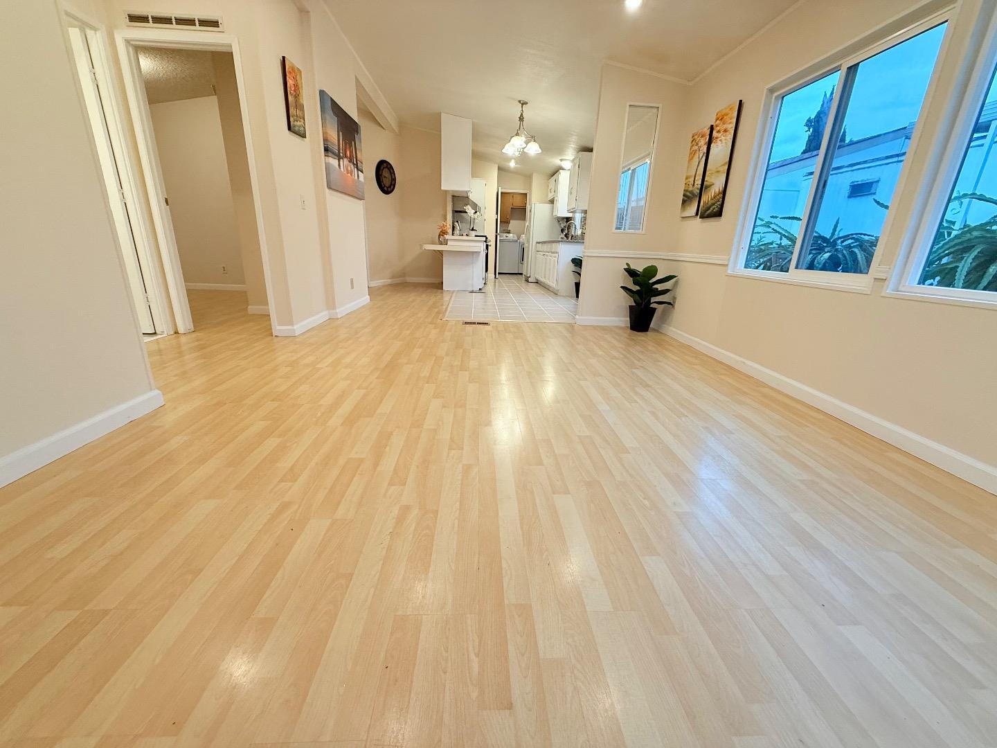 411 Lewis Road, Unit 335 San Jose, CA 95111 - Photo 4 of 27 a view of a living room with furniture and wooden floor
