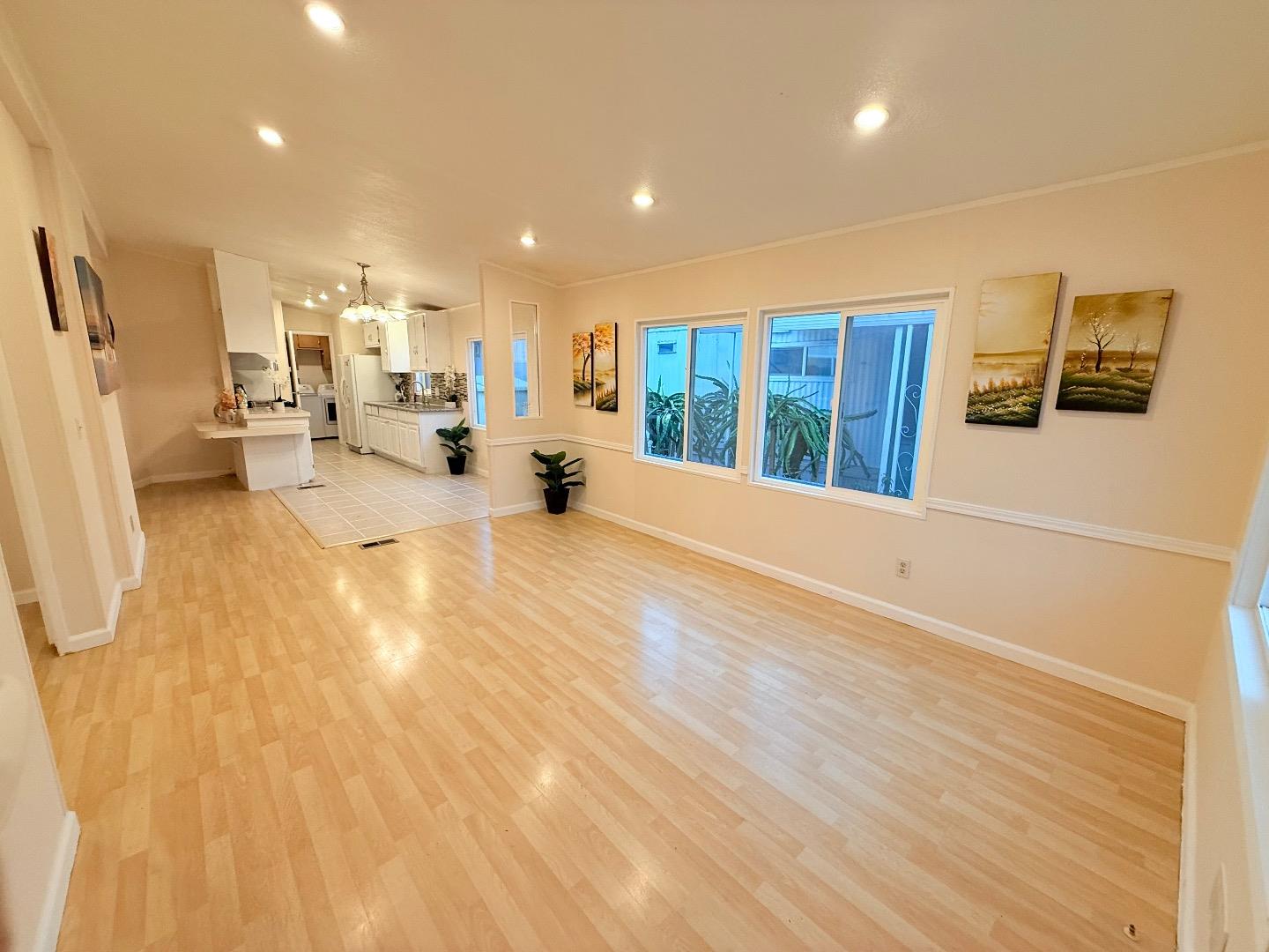 411 Lewis Road, Unit 335 San Jose, CA 95111 - Photo 5 of 27 a view of a living room a kitchen and a wooden floor
