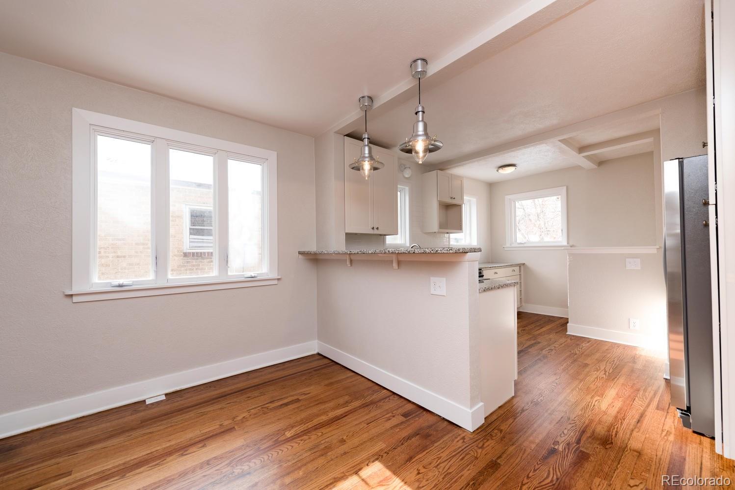 3527 Monroe Street Denver, CO 80205 - Photo 11 of 29 a view of a kitchen with wooden floor and a window