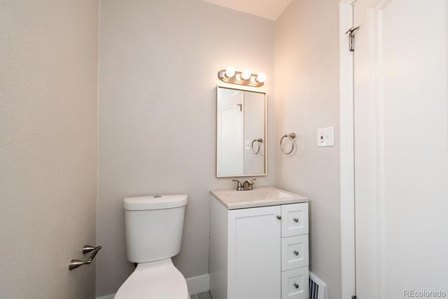 a white toilet sitting next to a bathroom sink