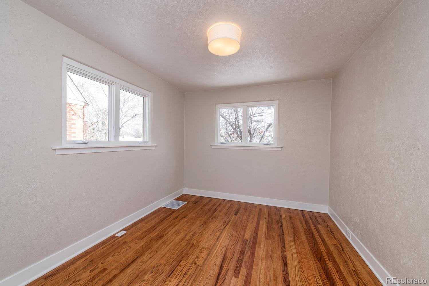 3527 Monroe Street Denver, CO 80205 - Photo 20 of 29 wooden floor in an empty room with a window