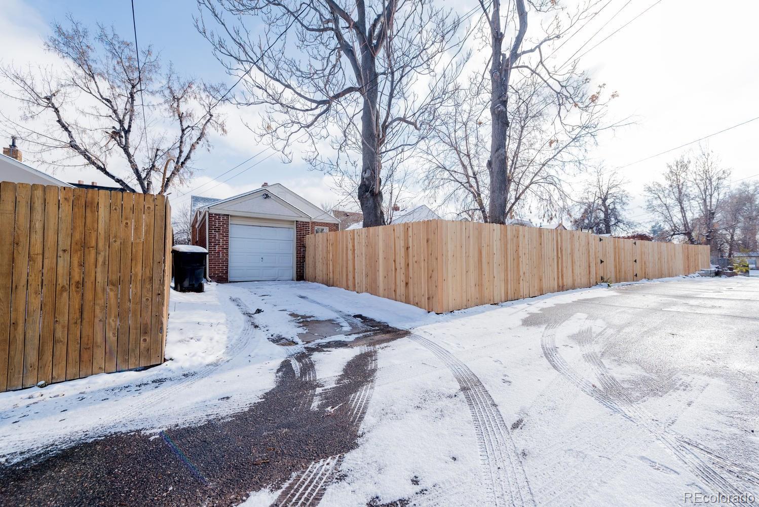 3527 Monroe Street Denver, CO 80205 - Photo 4 of 29 a view of a backyard with a barbeque and wooden fence
