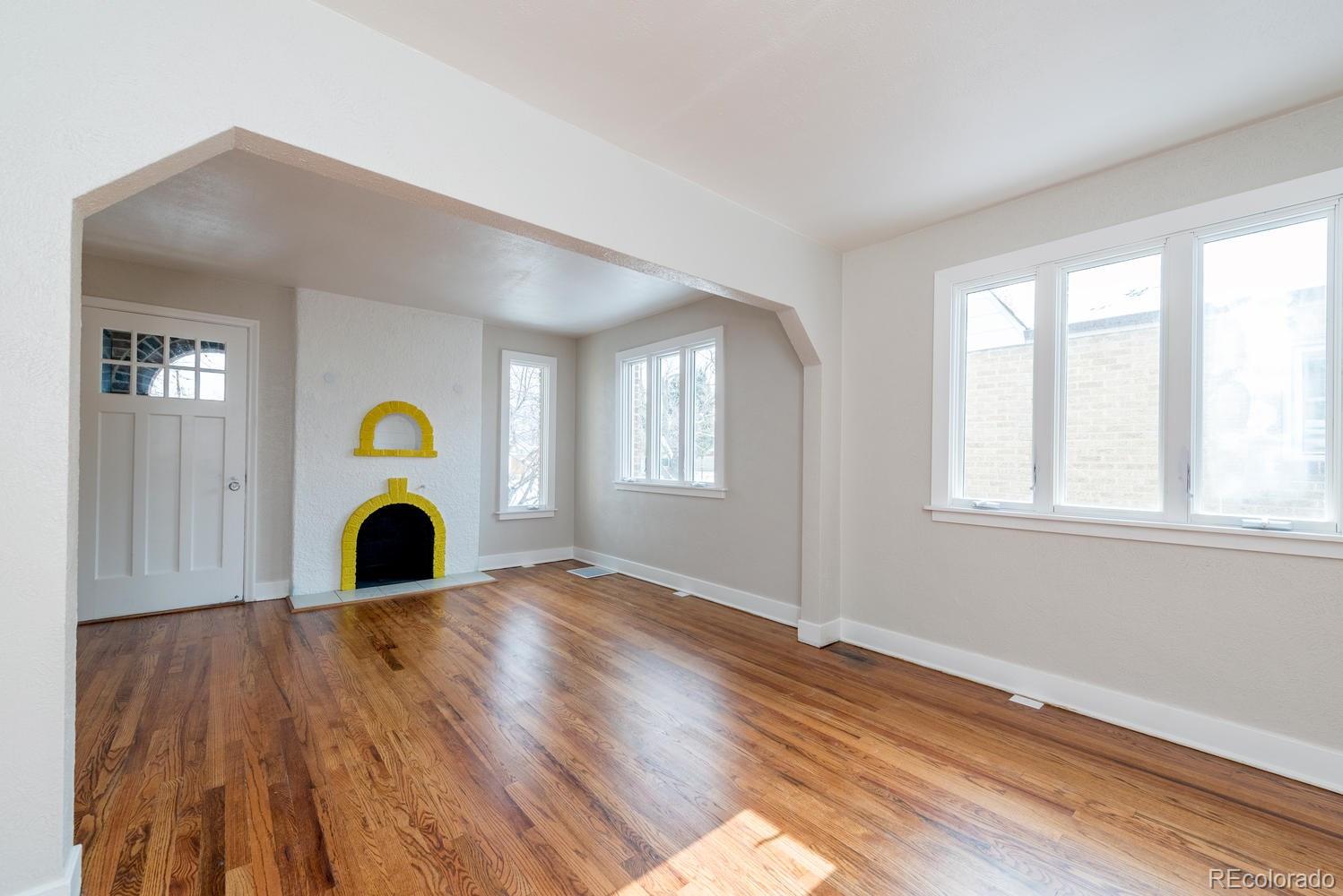3527 Monroe Street Denver, CO 80205 - Photo 5 of 29 a view of a livingroom with wooden floor and window
