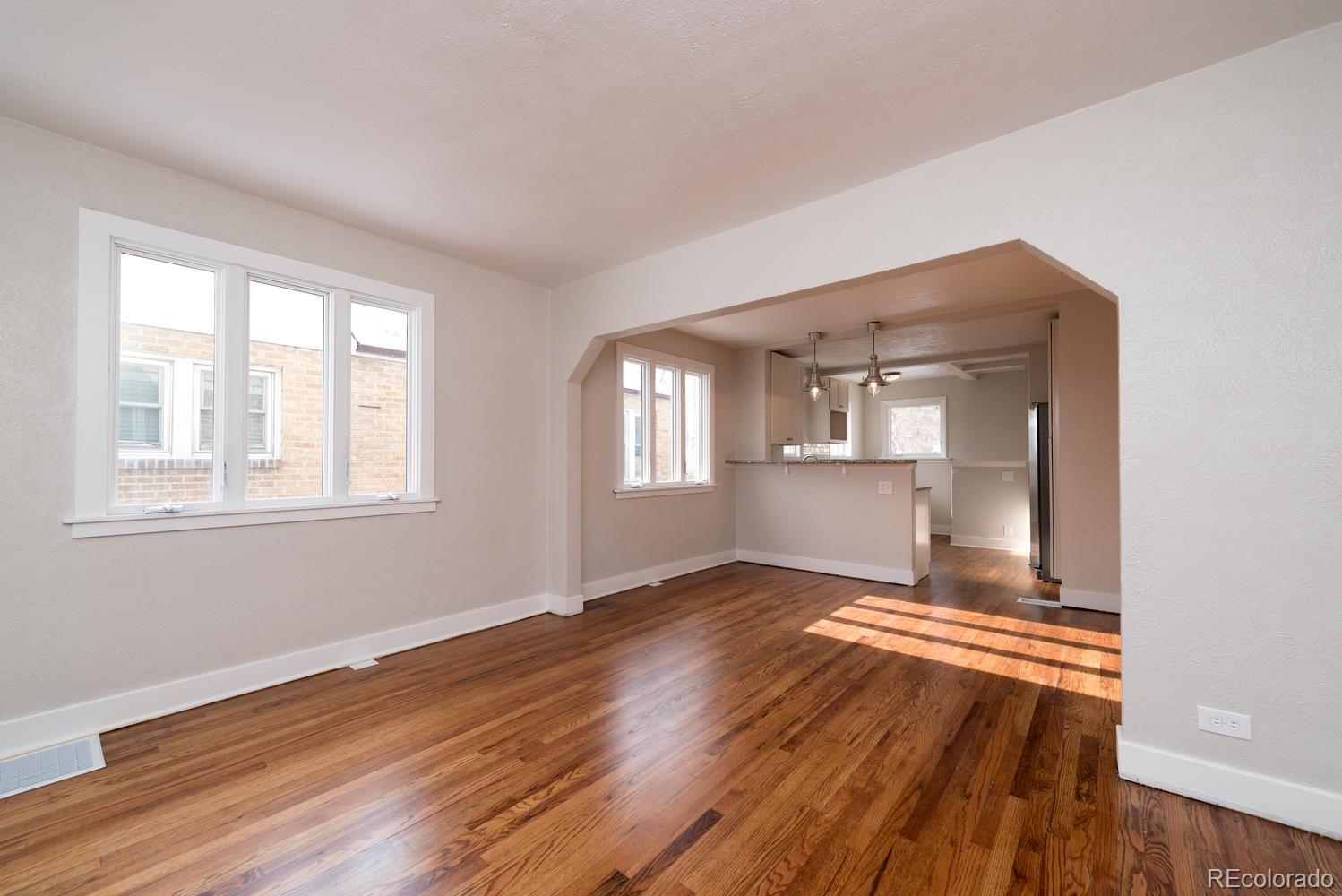 3527 Monroe Street Denver, CO 80205 - Photo 10 of 29 a view of wooden floor and windows in a room