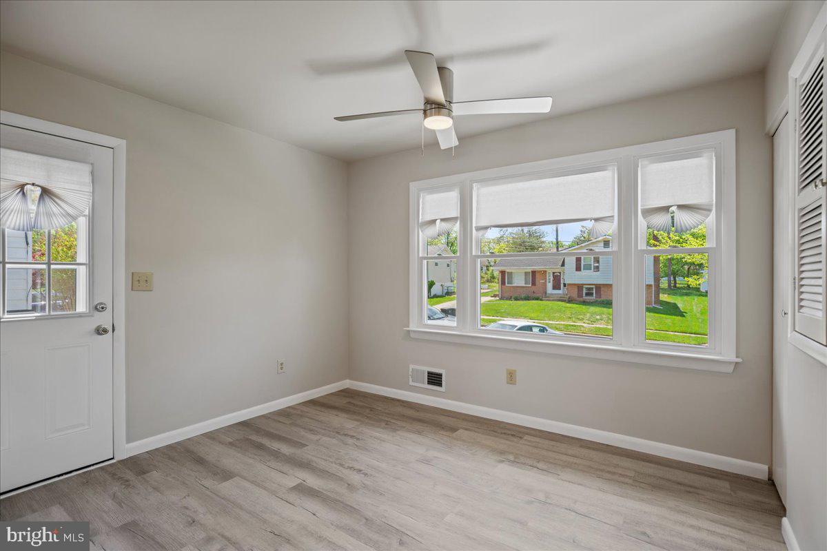 4227 Kinmount Road Lanham, MD 20706 - Photo 11 of 27 an empty room with a window and wooden floor