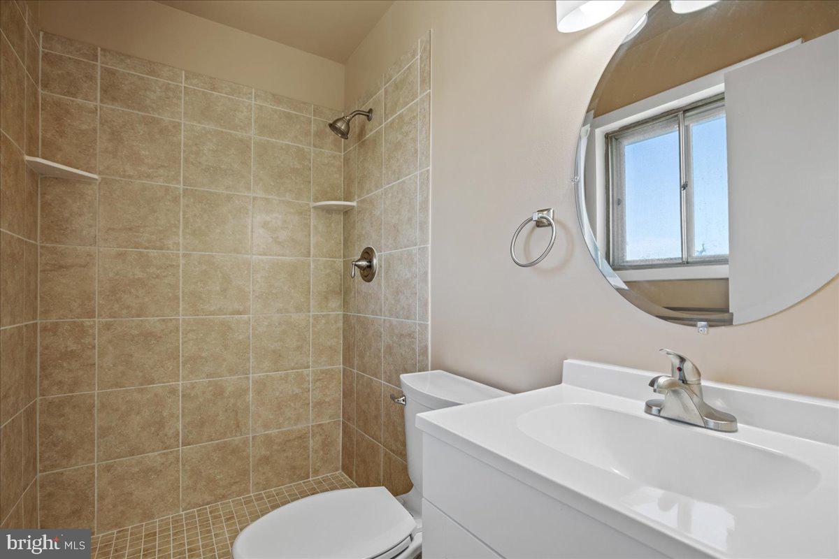 4227 Kinmount Road Lanham, MD 20706 - Photo 14 of 27 a bathroom with a sink a toilet and shower