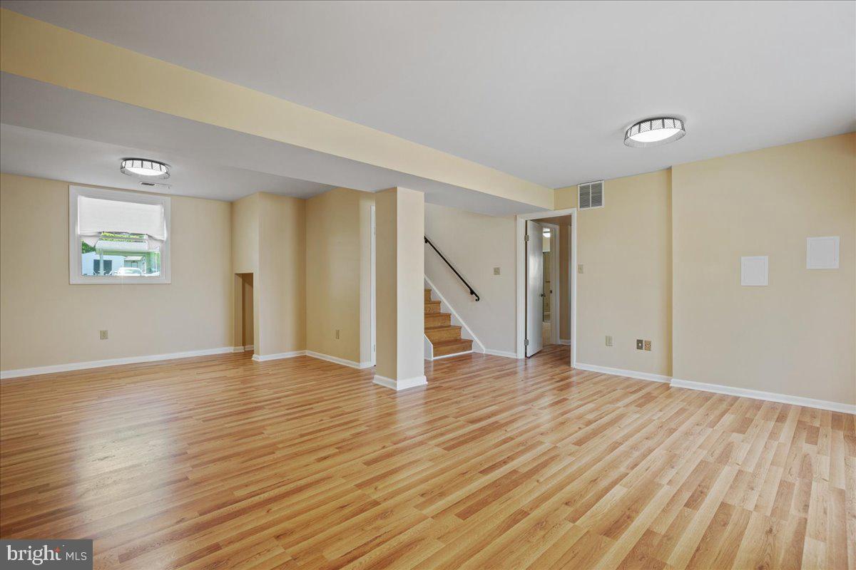 4227 Kinmount Road Lanham, MD 20706 - Photo 18 of 27 a view of an empty room with wooden floor and a window