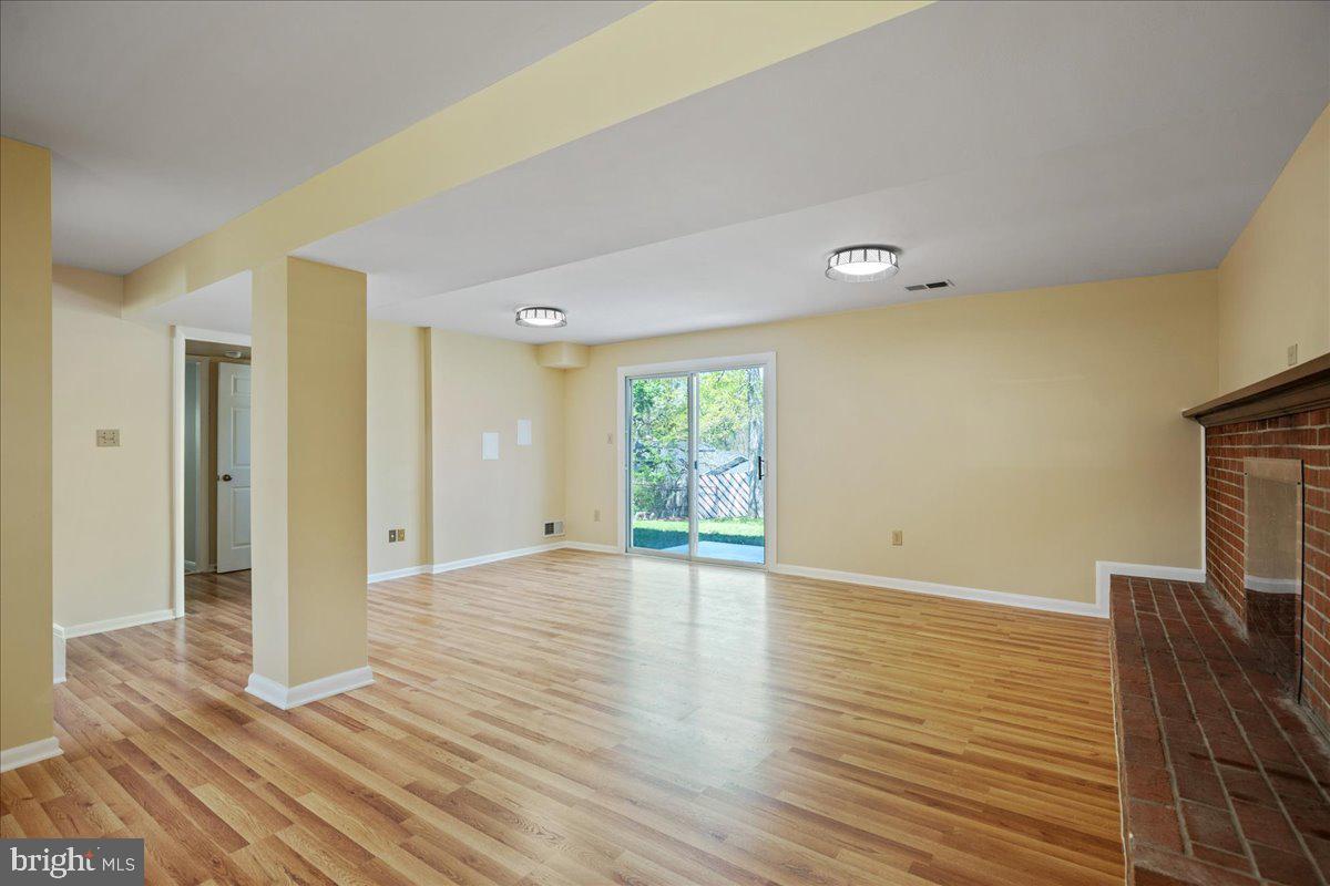 4227 Kinmount Road Lanham, MD 20706 - Photo 19 of 27 a view of an empty room with wooden floor and a window