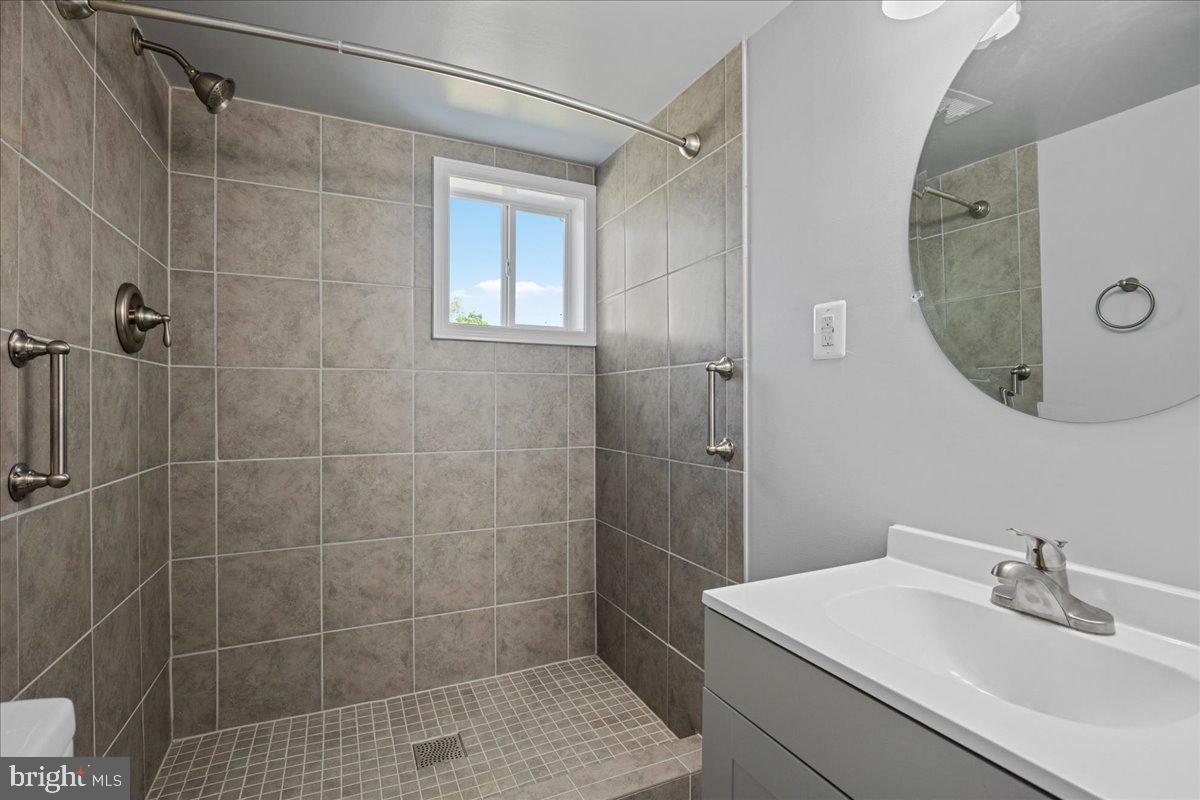 4227 Kinmount Road Lanham, MD 20706 - Photo 21 of 27 a bathroom with a sink shower and a mirror