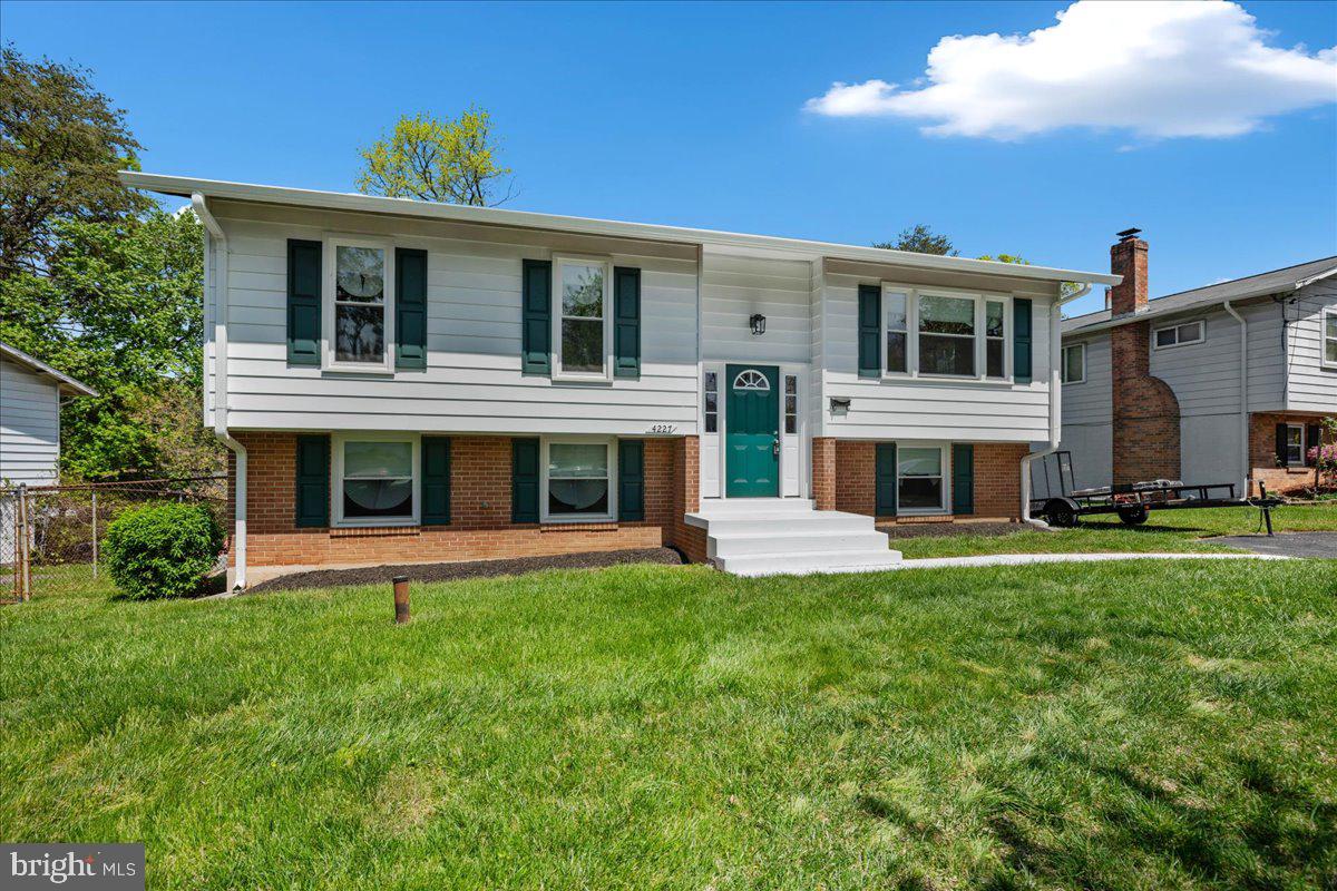 4227 Kinmount Road Lanham, MD 20706 - Photo 3 of 27 a front view of a house with a yard table and chairs