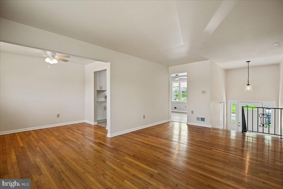 4227 Kinmount Road Lanham, MD 20706 - Photo 7 of 27 an empty room with wooden floor and windows