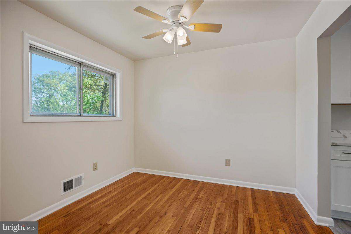 4227 Kinmount Road Lanham, MD 20706 - Photo 8 of 27 wooden floor in an empty room with a window
