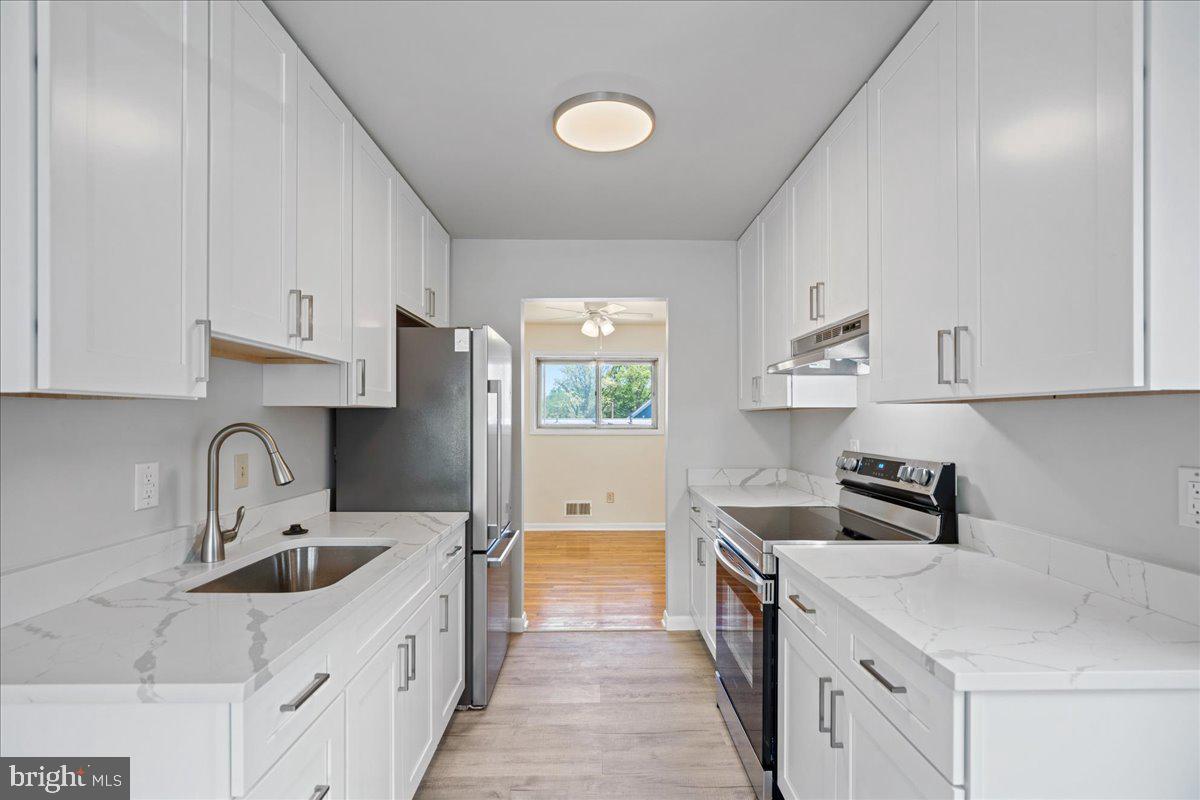4227 Kinmount Road Lanham, MD 20706 - Photo 9 of 27 a kitchen with a sink cabinets and appliances
