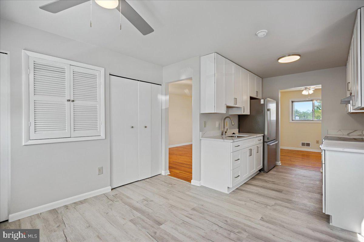 4227 Kinmount Road Lanham, MD 20706 - Photo 10 of 27 a kitchen with granite countertop a refrigerator and a stove top oven