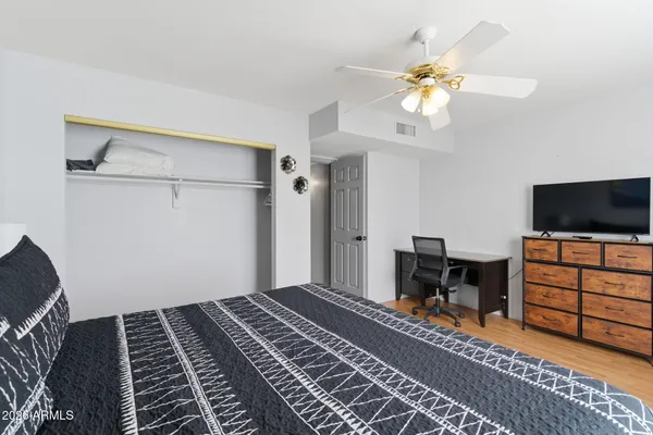 a bedroom with furniture and a flat screen tv