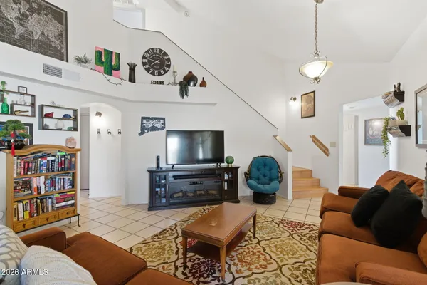 a view of backyard of a house with table and chairs
