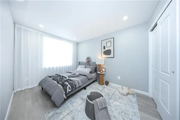 a bedroom with bed couch and window