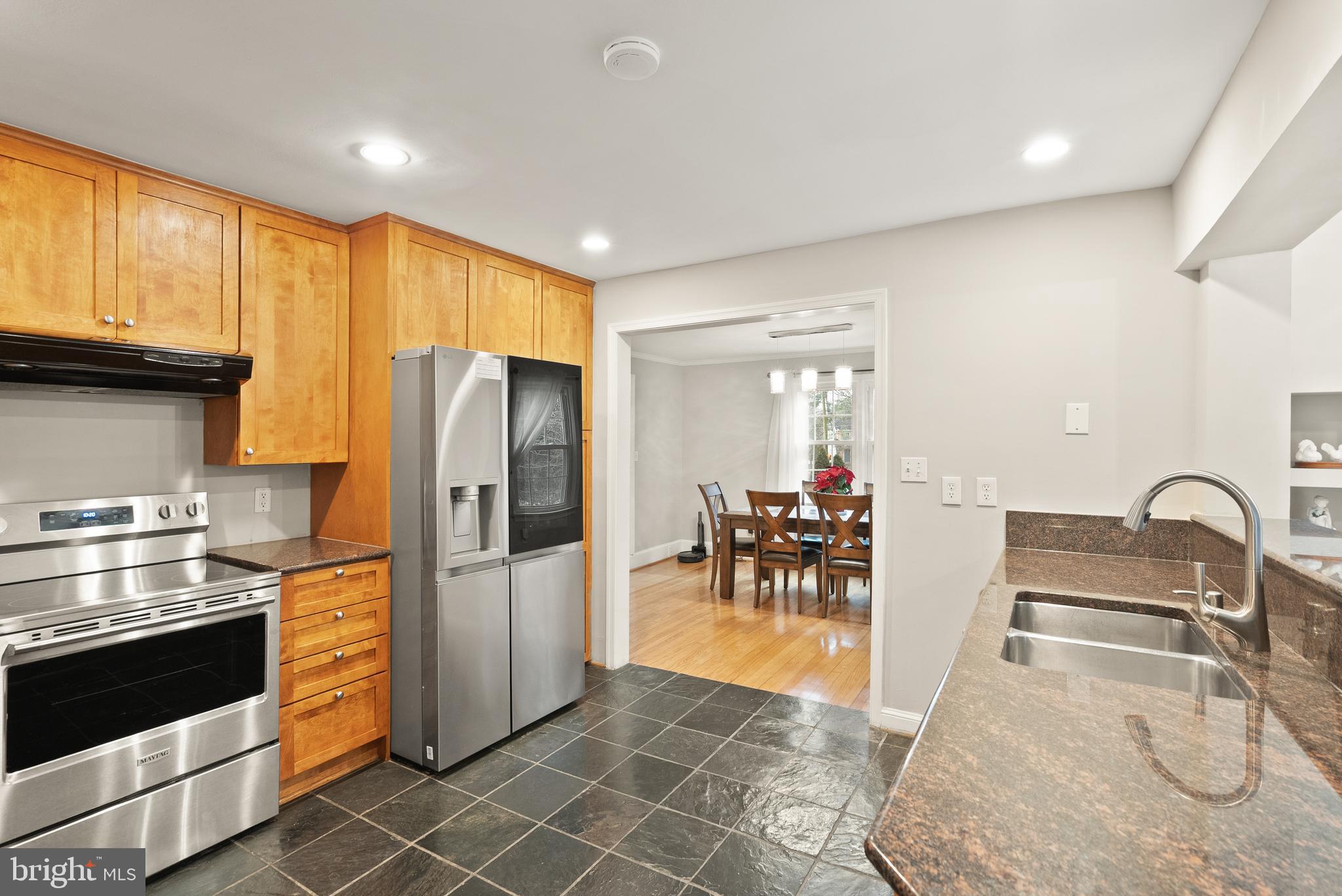 2928 Hunter Road Fairfax, VA 22031 - Photo 20 of 73 a kitchen with granite countertop a refrigerator and a stove top oven